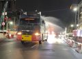 Brimob PMJ Semprot Jalan dan Bagikan Masker ke Warga