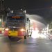 Brimob PMJ Semprot Jalan dan Bagikan Masker ke Warga